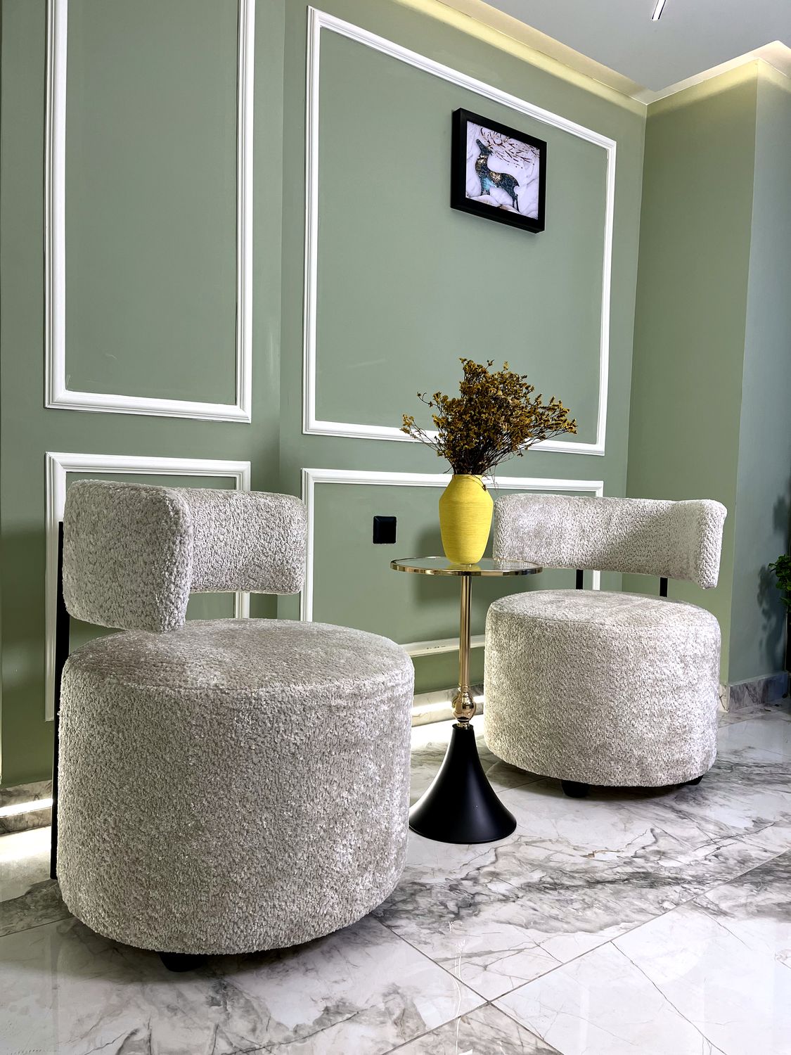 Waiting corner with beige seating and a side table