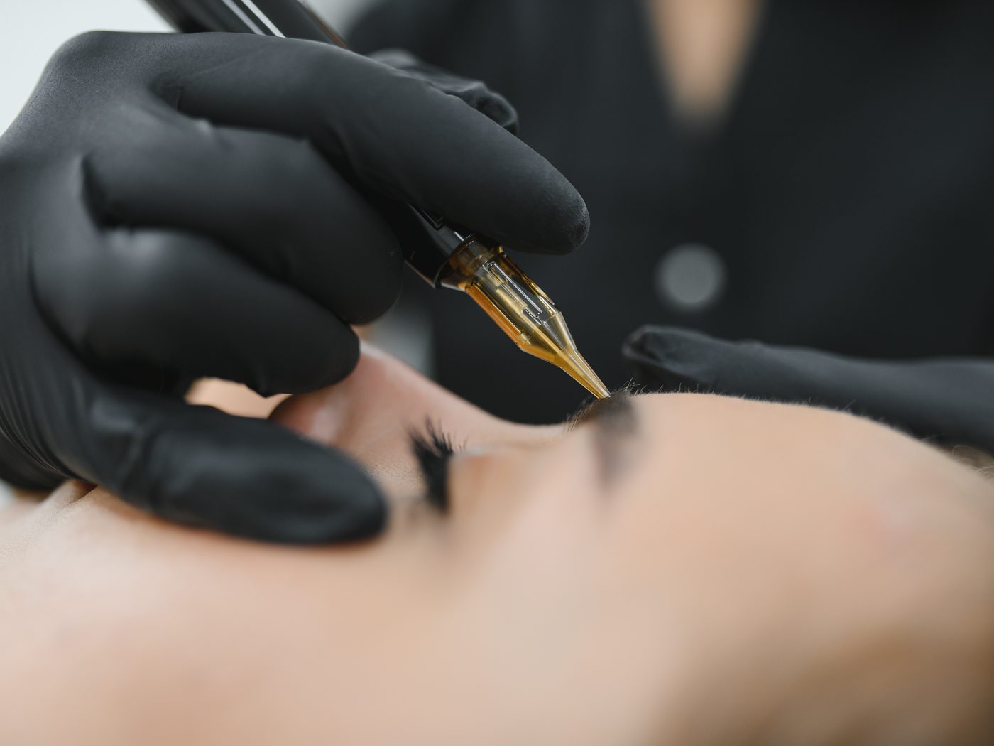 Microblading — drawing brow hairstrokes by hand with a fine blade